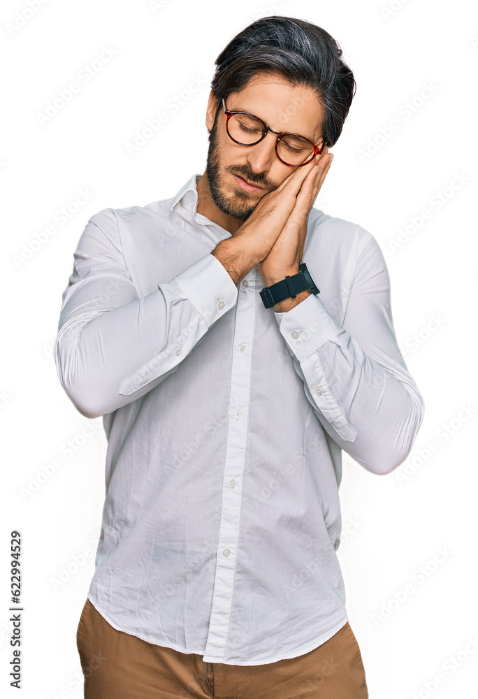 Young hispanic man wearing business shirt and glasses sleeping tired dreaming and posing with hands together while smiling with closed eyes. Young hispanic man wearing business shirt and glasses sleeping tired dreaming and posing with hands together while smiling with closed eyes.