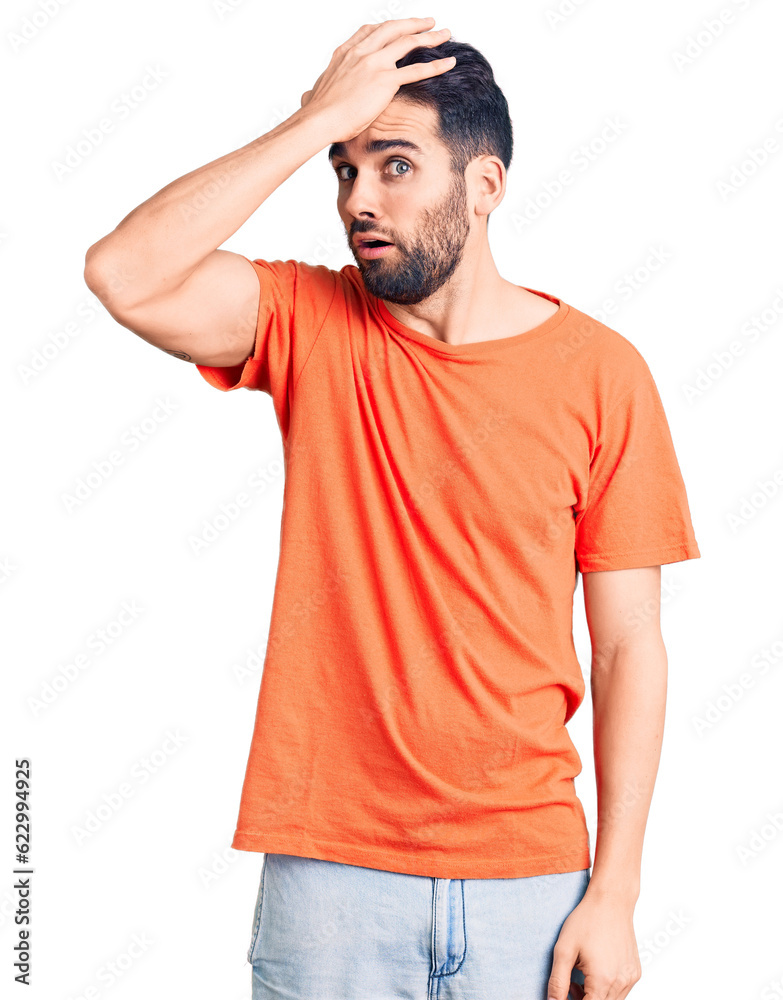Young handsome man with beard wearing casual t-shirt surprised with hand on head for mistake, remember error. forgot, bad memory concept. Young handsome man with beard wearing casual t-shirt surprised with hand on head for mistake, remember error. forgot, bad memory concept.