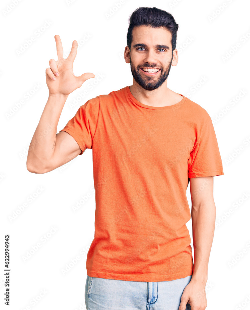 Young handsome man with beard wearing casual t-shirt showing and pointing up with fingers number three while smiling confident and happy. Young handsome man with beard wearing casual t-shirt showing and pointing up with fingers number three while smiling confident and happy.