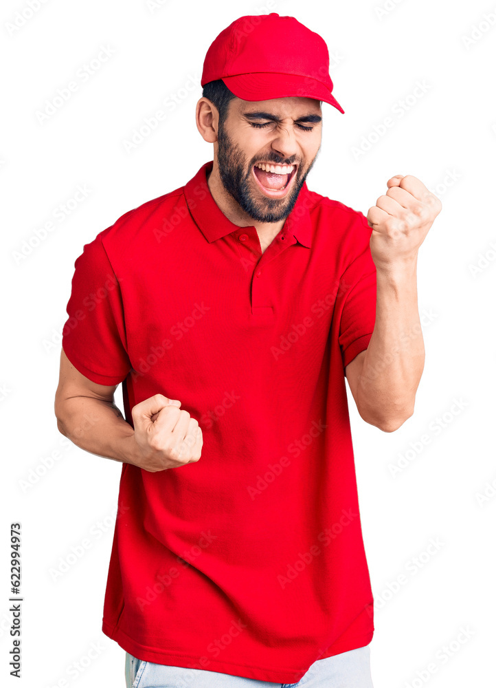 Young handsome man with beard wearing delivery uniform celebrating surprised and amazed for success with arms raised and eyes closed. winner concept. Young handsome man with beard wearing delivery uniform celebrating surprised and amazed for success with arms raised and eyes closed. winner concept.