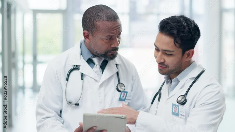 Hospital, doctors and men on tablet in discussion for diagnosis, medical results and report in clinic. Healthcare, team and male health workers on digital tech for telehealth, analysis and research
