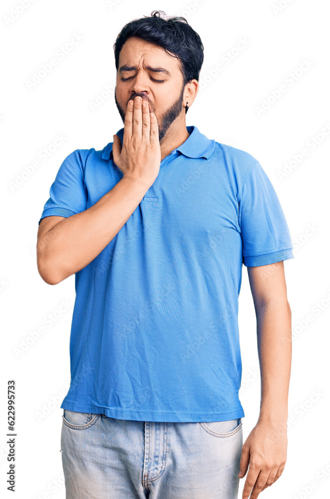 Young hispanic man wearing casual clothes bored yawning tired covering mouth with hand. restless and sleepiness. Young hispanic man wearing casual clothes bored yawning tired covering mouth with hand. restless and sleepiness.