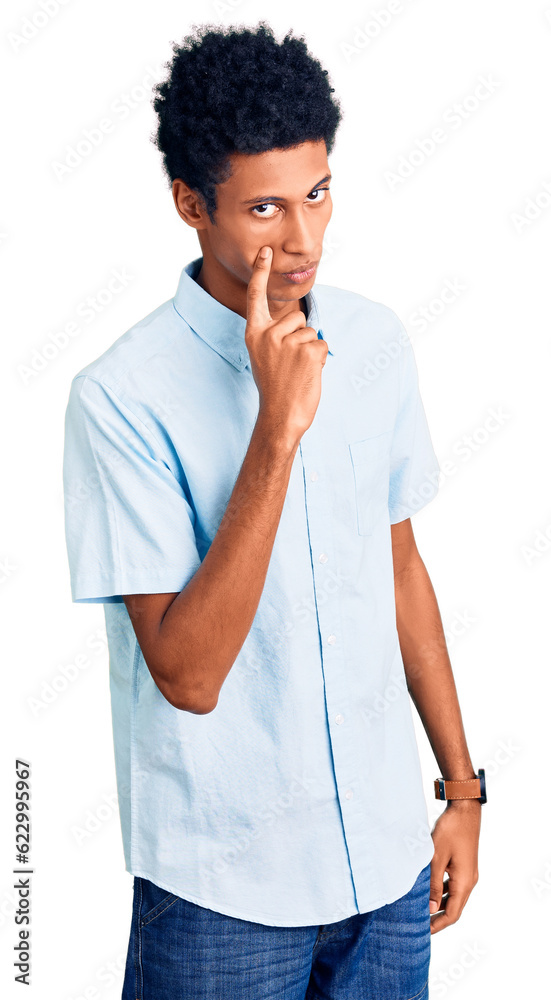 Young african american man wearing casual clothes pointing to the eye watching you gesture, suspicious expression Young african american man wearing casual clothes pointing to the eye watching you gesture, suspicious expression