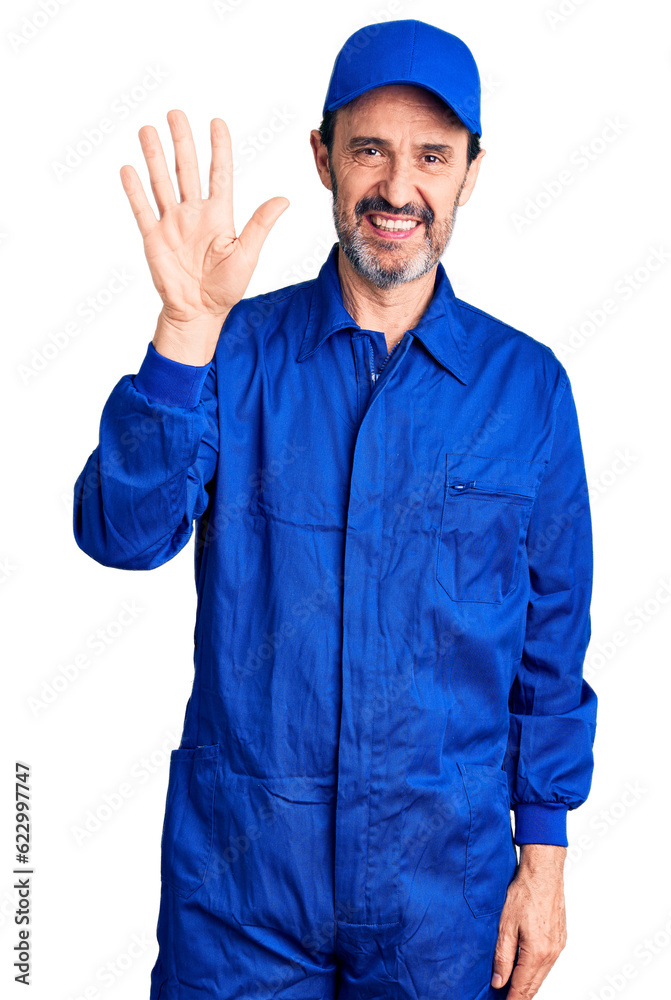 Middle age handsome man wearing mechanic uniform showing and pointing up with fingers number five while smiling confident and happy.