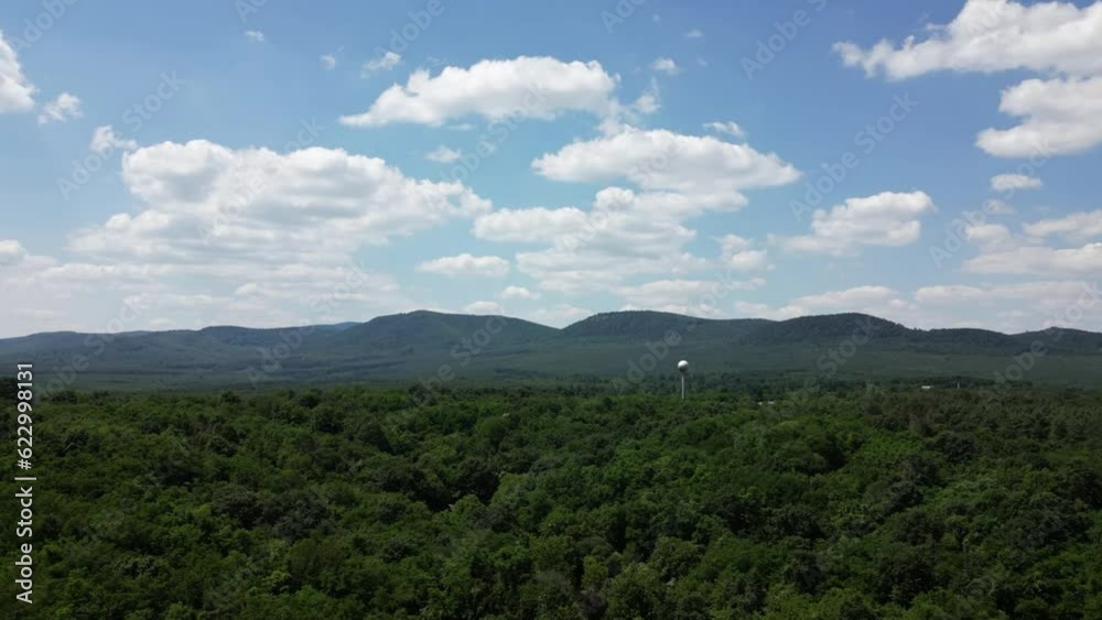 Aerial hyperlapse of clouds on a sunny day - approaching the hills of Börzsöny, Hungary - water tower sphere in the forest Aerial hyperlapse of clouds on a sunny day - approaching the hills of Börzsöny, Hungary - water tower sphere in the forest