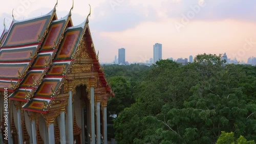 Forward drone travelling at Wat Kong Kaeo buddhist temple in Bang Kachao. Religious place in the jungle during beautiful sunset with background view of Bangkok, Thailand. photo