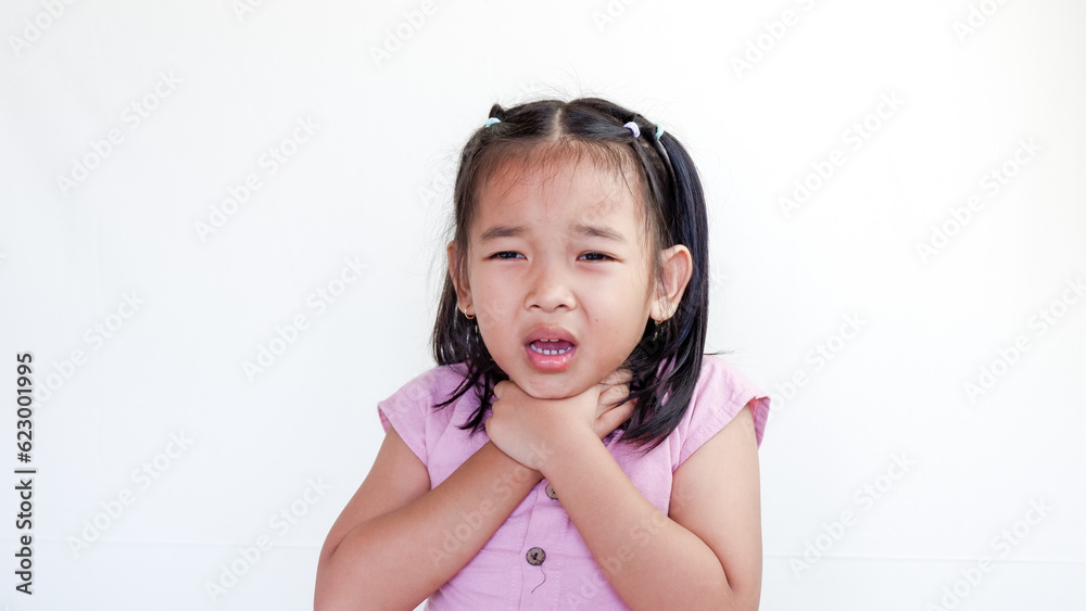 Little Asian girl with sore throat touching her neck. Sore throat sick. Little girl having pain in her throat. Little Asian girl with sore throat touching her neck. Sore throat sick. Little girl having pain in her throat.