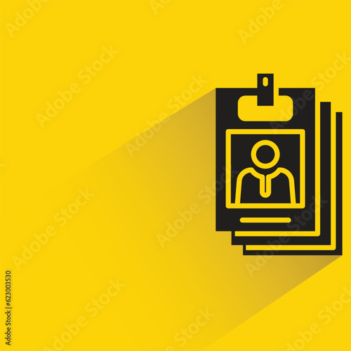 stack of id cards with shadow on yellow background