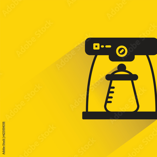coffee machine with shadow on yellow background