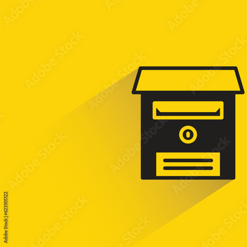 postbox with shadow on yellow background