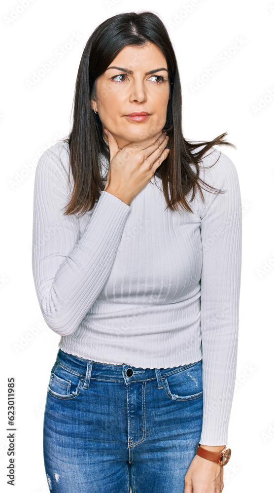 Beautiful brunette woman wearing casual clothes touching painful neck, sore throat for flu, clod and infection Beautiful brunette woman wearing casual clothes touching painful neck, sore throat for flu, clod and infection