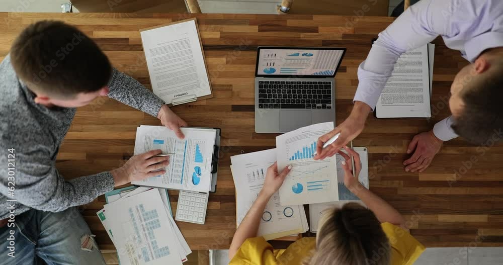Colleagues working with financial documents project statistics in office top view. Seo woman with colleagues developing business strategy and teamwork
