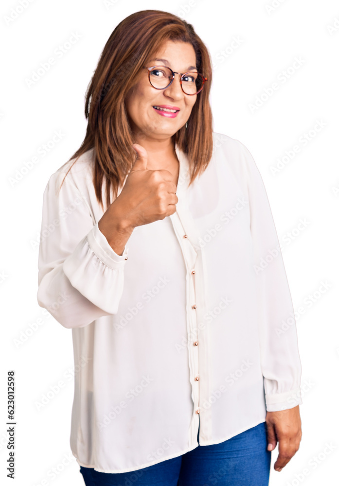 Middle age latin woman wearing casual clothes and glasses doing happy thumbs up gesture with hand. approving expression looking at the camera showing success. Middle age latin woman wearing casual clothes and glasses doing happy thumbs up gesture with hand. approving expression looking at the camera showing success.