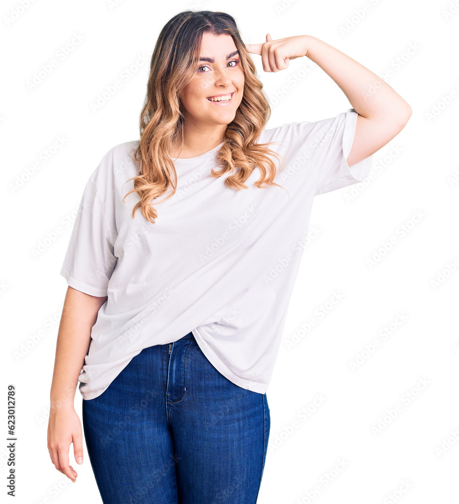 Fototapeta premium Young caucasian woman wearing casual clothes smiling pointing to head with one finger, great idea or thought, good memory