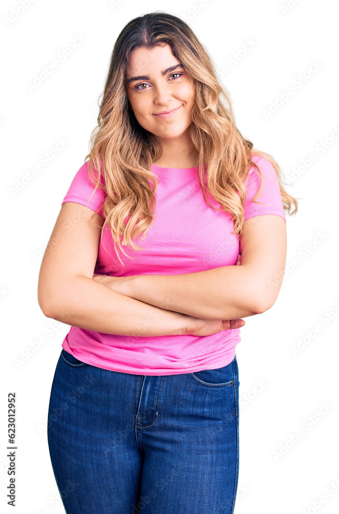 Young caucasian woman wearing sportswear happy face smiling with crossed arms looking at the camera. positive person. Young caucasian woman wearing sportswear happy face smiling with crossed arms looking at the camera. positive person.
