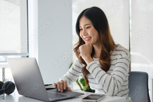 Young woman engaged in online study or project work.