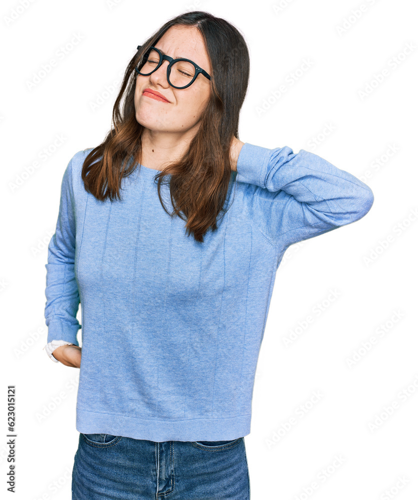 Young beautiful woman wearing casual clothes and glasses suffering of neck ache injury, touching neck with hand, muscular pain Young beautiful woman wearing casual clothes and glasses suffering of neck ache injury, touching neck with hand, muscular pain