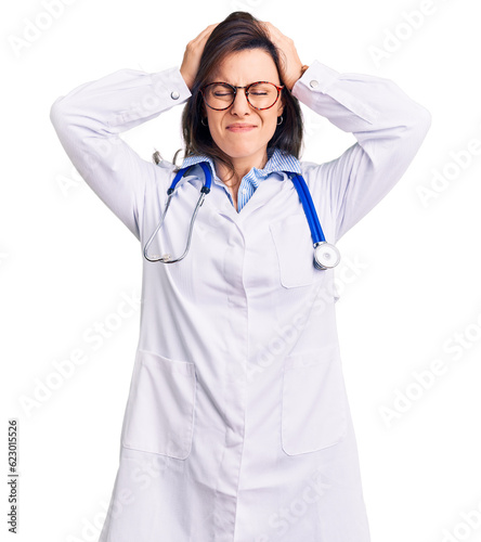 Obraz na plátně Young beautiful woman wearing doctor stethoscope and glasses suffering from headache desperate and stressed because pain and migraine
