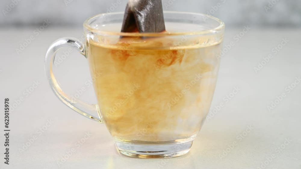 Dipping tea bags in hot water.