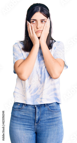 Young beautiful girl wearing casual t shirt tired hands covering face, depression and sadness, upset and irritated for problem