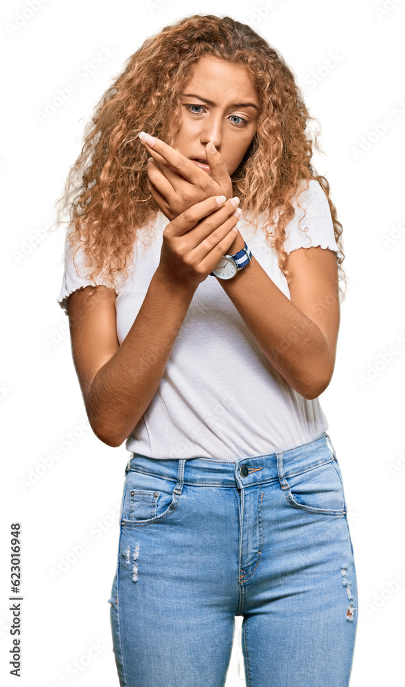 Beautiful caucasian teenager girl wearing casual white tshirt suffering pain on hands and fingers, arthritis inflammation Beautiful caucasian teenager girl wearing casual white tshirt suffering pain on hands and fingers, arthritis inflammation