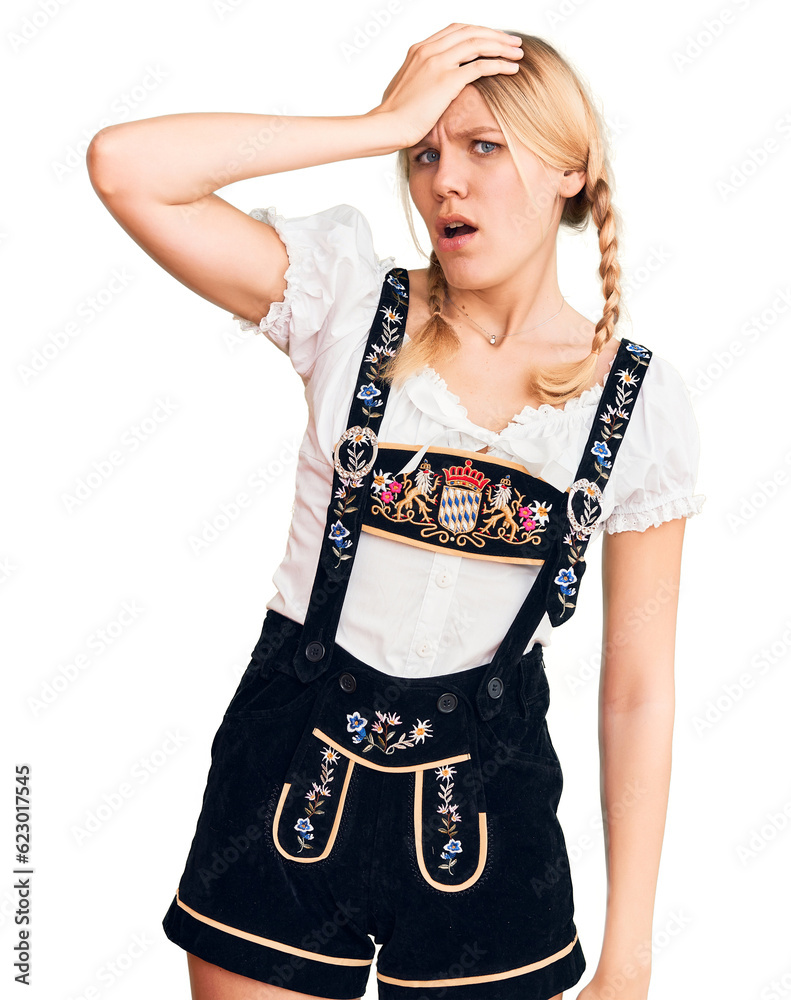 Young beautiful blonde woman wearing oktoberfest dress surprised with hand on head for mistake, remember error. forgot, bad memory concept. Young beautiful blonde woman wearing oktoberfest dress surprised with hand on head for mistake, remember error. forgot, bad memory concept.