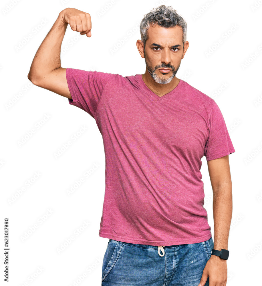 Middle age grey-haired man wearing casual clothes strong person showing arm muscle, confident and proud of power Middle age grey-haired man wearing casual clothes strong person showing arm muscle, confident and proud of power