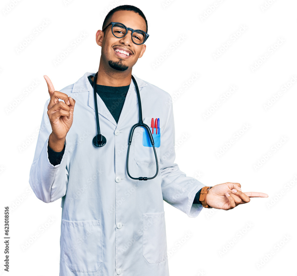 Young african american man wearing doctor uniform and stethoscope smiling confident pointing with fingers to different directions. copy space for advertisement Young african american man wearing doctor uniform and stethoscope smiling confident pointing with fingers to different directions. copy space for advertisement