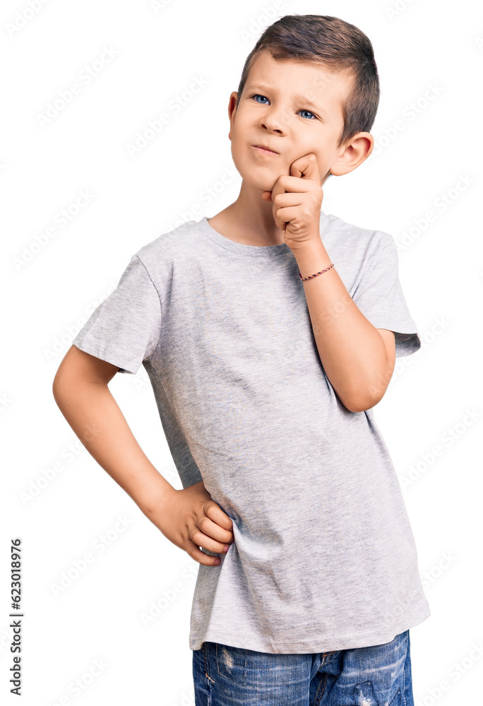 Cute blond kid wearing casual clothes serious face thinking about question with hand on chin, thoughtful about confusing idea Cute blond kid wearing casual clothes serious face thinking about question with hand on chin, thoughtful about confusing idea