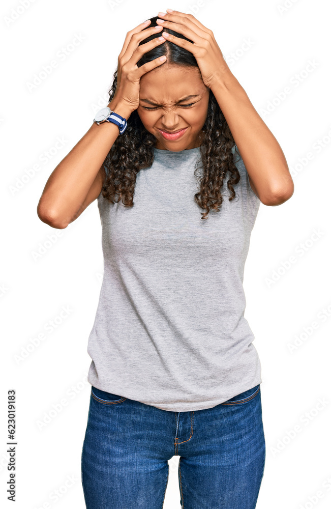 Young african american girl wearing casual clothes suffering from headache desperate and stressed because pain and migraine. hands on head. Young african american girl wearing casual clothes suffering from headache desperate and stressed because pain and migraine. hands on head.