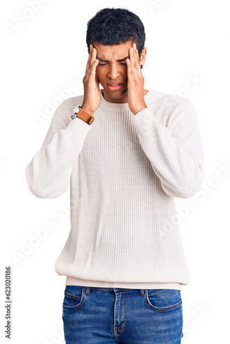 Young african amercian man wearing casual clothes with hand on head, headache because stress. suffering migraine.