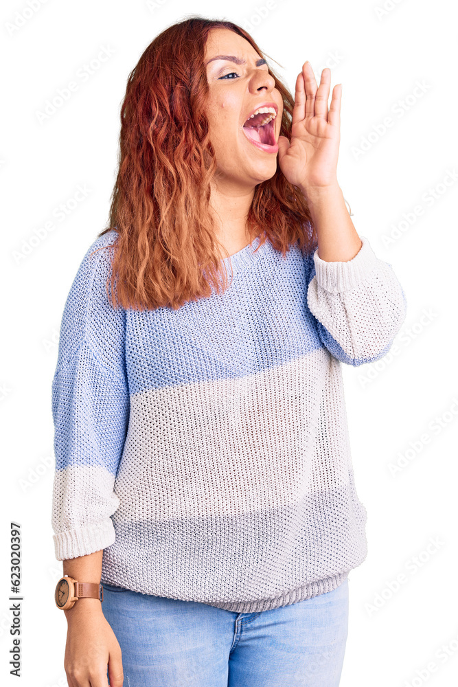 Young latin woman wearing casual clothes shouting and screaming loud to side with hand on mouth. communication concept. Young latin woman wearing casual clothes shouting and screaming loud to side with hand on mouth. communication concept.