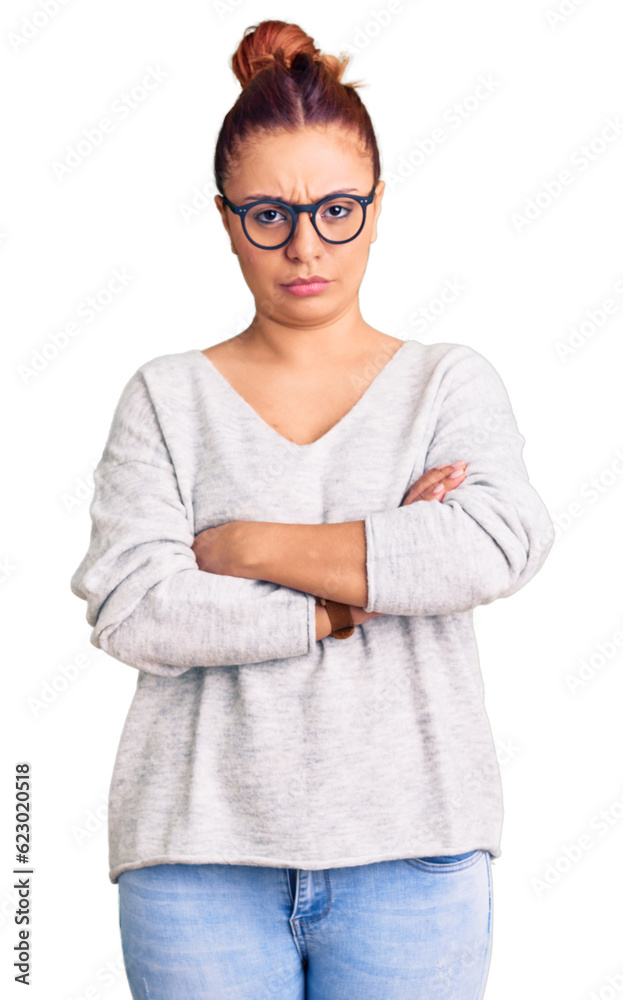 Young latin woman wearing casual clothes skeptic and nervous, disapproving expression on face with crossed arms. negative person. Young latin woman wearing casual clothes skeptic and nervous, disapproving expression on face with crossed arms. negative person.
