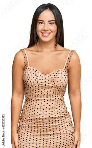 Young beautiful hispanic girl wearing sexy party dress with a happy and cool smile on face. lucky person.