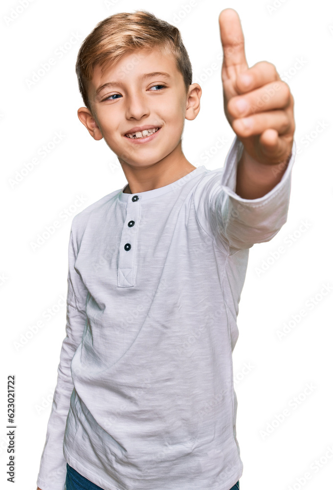 Little caucasian boy kid wearing casual clothes smiling friendly offering handshake as greeting and welcoming. successful business. Little caucasian boy kid wearing casual clothes smiling friendly offering handshake as greeting and welcoming. successful business.