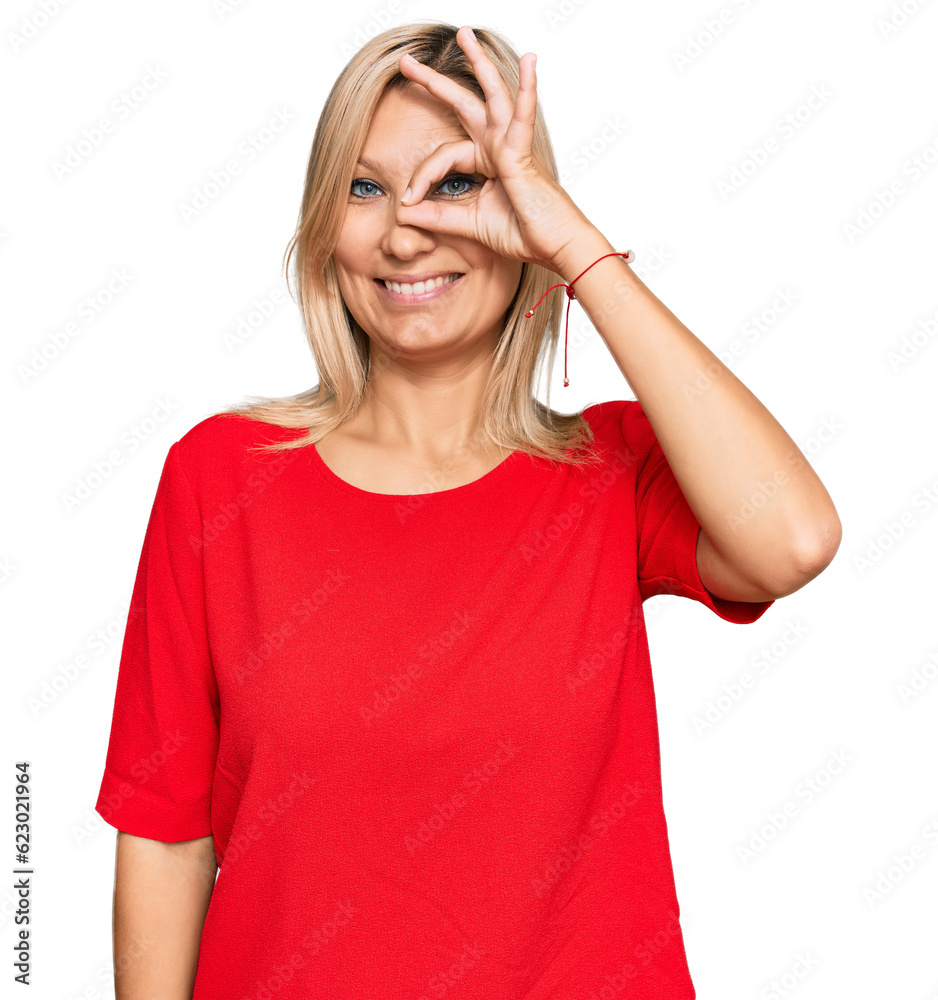Middle age caucasian woman wearing casual clothes doing ok gesture with hand smiling, eye looking through fingers with happy face. Middle age caucasian woman wearing casual clothes doing ok gesture with hand smiling, eye looking through fingers with happy face.