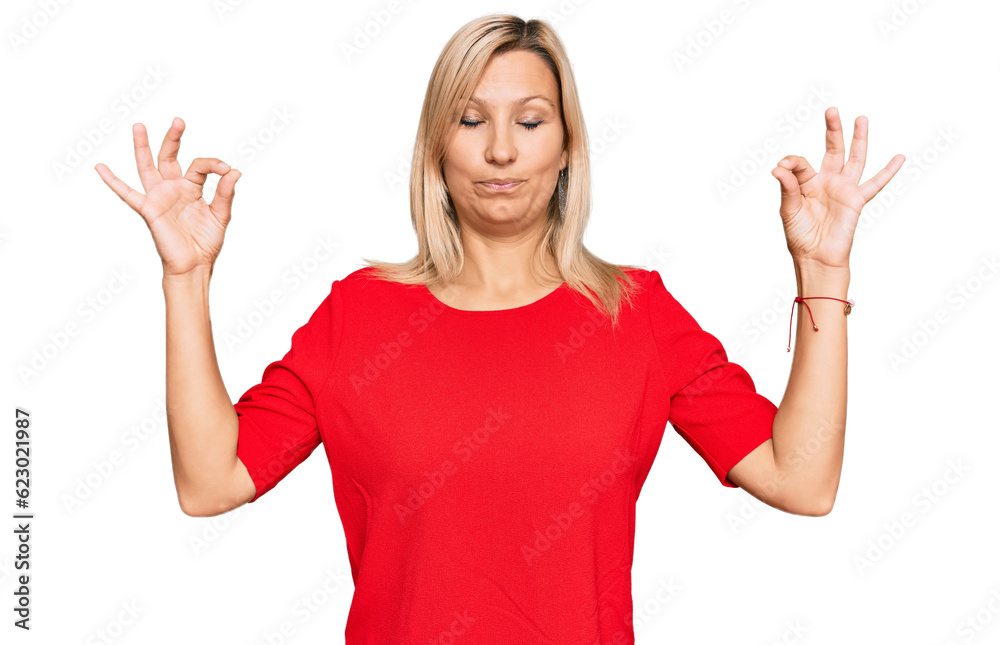 Middle age caucasian woman wearing casual clothes relax and smiling with eyes closed doing meditation gesture with fingers. yoga concept. Middle age caucasian woman wearing casual clothes relax and smiling with eyes closed doing meditation gesture with fingers. yoga concept.