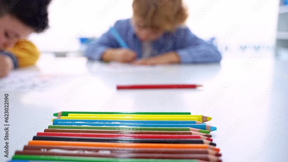 Children drawing paint with colorful pencils coloring book in educational class at school. Art creative lessons developing imagination fine motor skills