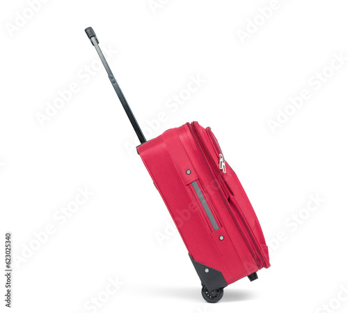 Red suitcase on wheels with the handle extended in the running position, side view, isolated on a transparent background png.