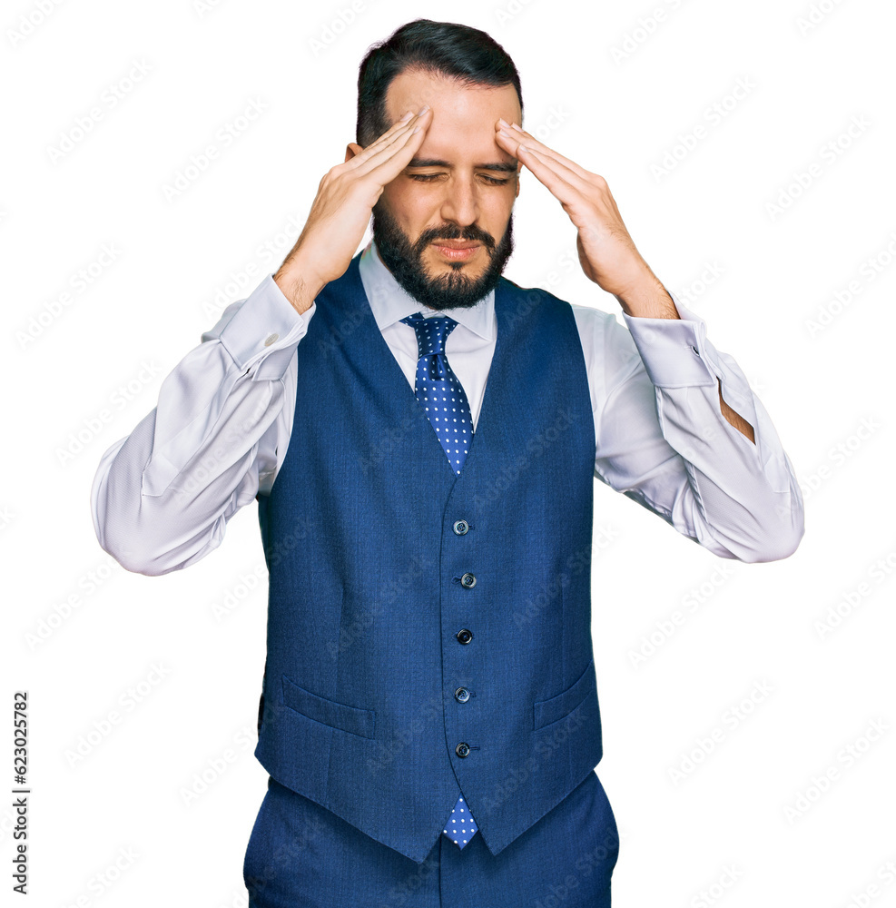 Young man with beard wearing business vest with hand on head for pain in head because stress. suffering migraine. Young man with beard wearing business vest with hand on head for pain in head because stress. suffering migraine.