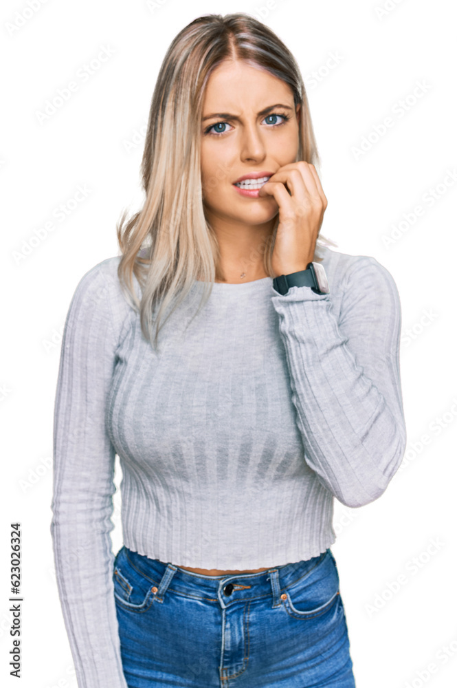 Beautiful blonde woman wearing casual clothes looking stressed and nervous with hands on mouth biting nails. anxiety problem. Beautiful blonde woman wearing casual clothes looking stressed and nervous with hands on mouth biting nails. anxiety problem.