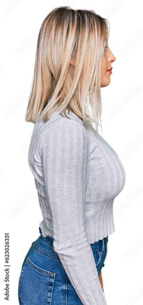 Beautiful blonde woman wearing casual clothes looking to side, relax profile pose with natural face and confident smile. Beautiful blonde woman wearing casual clothes looking to side, relax profile pose with natural face and confident smile.