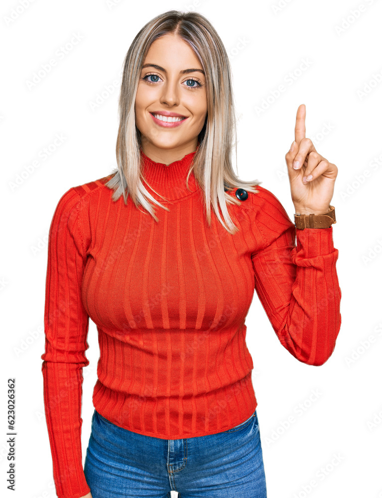 Beautiful blonde woman wearing casual clothes showing and pointing up with finger number one while smiling confident and happy. Beautiful blonde woman wearing casual clothes showing and pointing up with finger number one while smiling confident and happy.