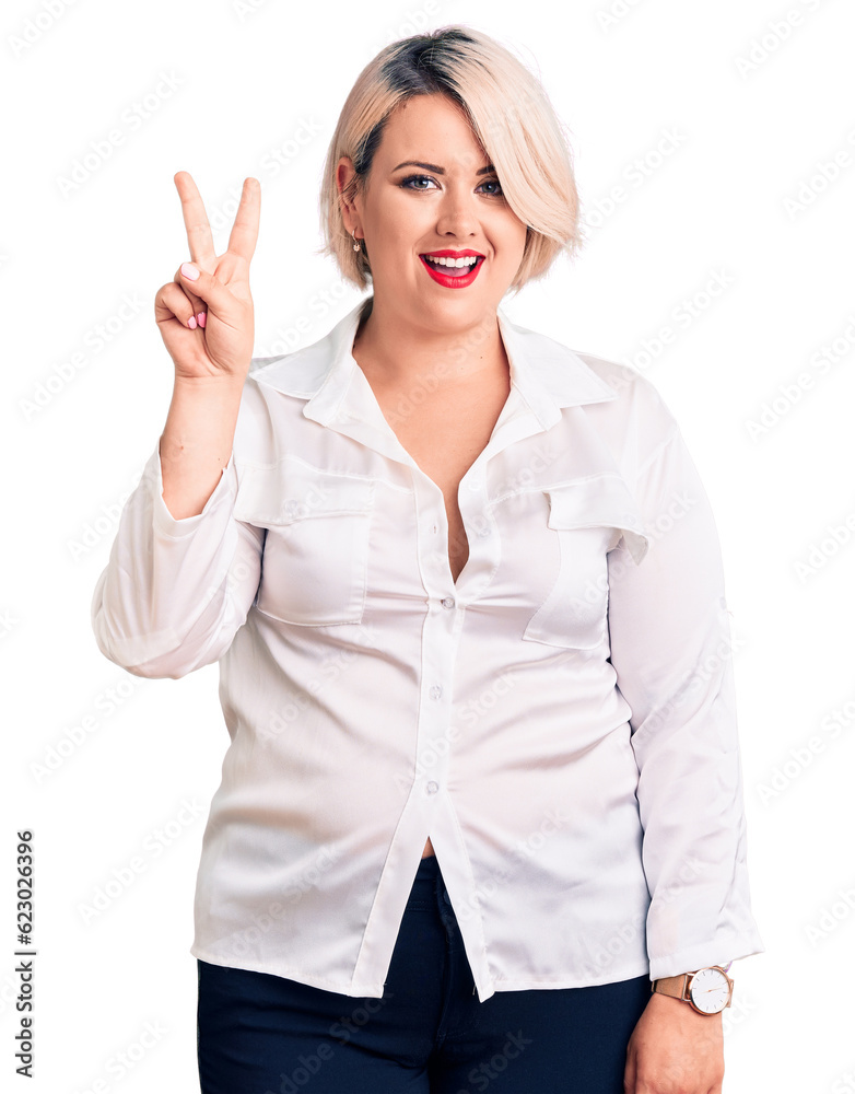 Young blonde plus size woman wearing casual shirt showing and pointing up with fingers number two while smiling confident and happy. Young blonde plus size woman wearing casual shirt showing and pointing up with fingers number two while smiling confident and happy.
