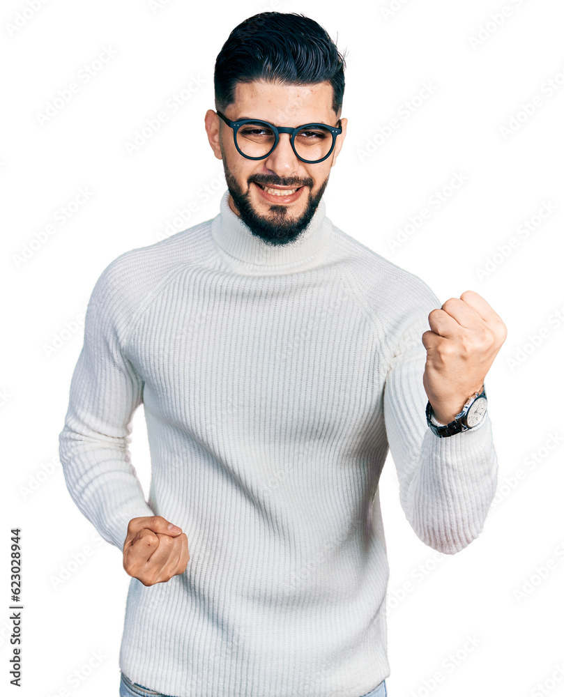 Young arab man with beard wearing elegant turtleneck sweater and glasses celebrating surprised and amazed for success with arms raised and eyes closed. winner concept. Young arab man with beard wearing elegant turtleneck sweater and glasses celebrating surprised and amazed for success with arms raised and eyes closed. winner concept.