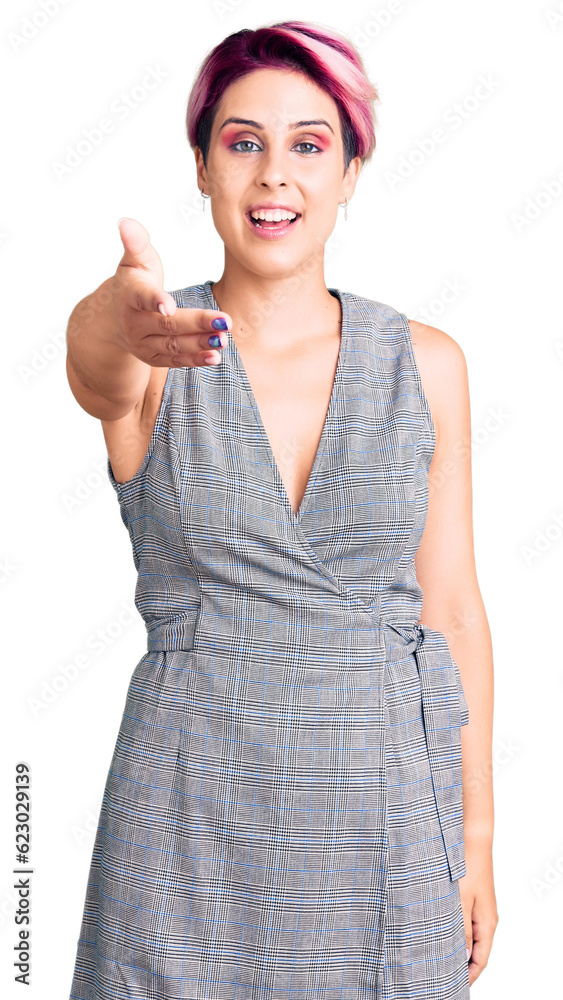 Young beautiful woman with pink hair wearing casual clothes smiling friendly offering handshake as greeting and welcoming. successful business. Young beautiful woman with pink hair wearing casual clothes smiling friendly offering handshake as greeting and welcoming. successful business.