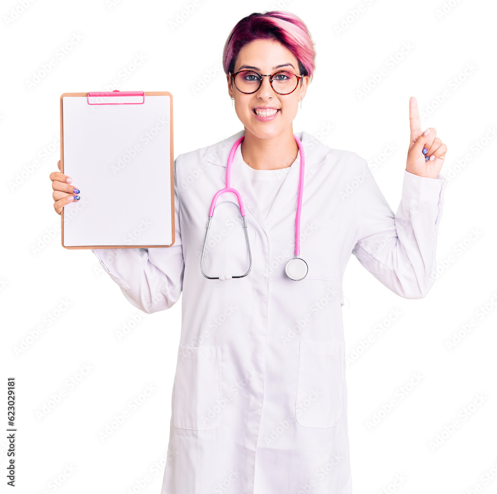 Young beautiful woman with pink hair wearing doctor stethoscope holding clipboard with medical report surprised with an idea or question pointing finger with happy face, number one Young beautiful woman with pink hair wearing doctor stethoscope holding clipboard with medical report surprised with an idea or question pointing finger with happy face, number one