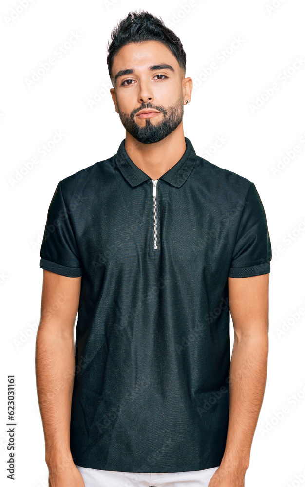 Fototapeta premium Young man with beard wearing sportswear relaxed with serious expression on face. simple and natural looking at the camera.