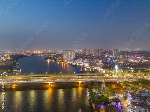 Aerial view of a Ho Chi Minh City  Vietnam with development buildings  transportation  energy power infrastructure. Financial and business centers. Sunset to night.