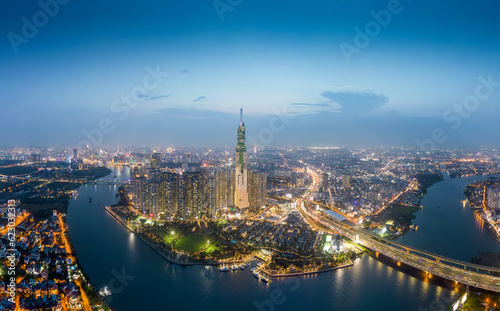 Aerial view of a Ho Chi Minh City, Vietnam with development buildings, transportation, energy power infrastructure. Financial and business centers. Sunset to night.